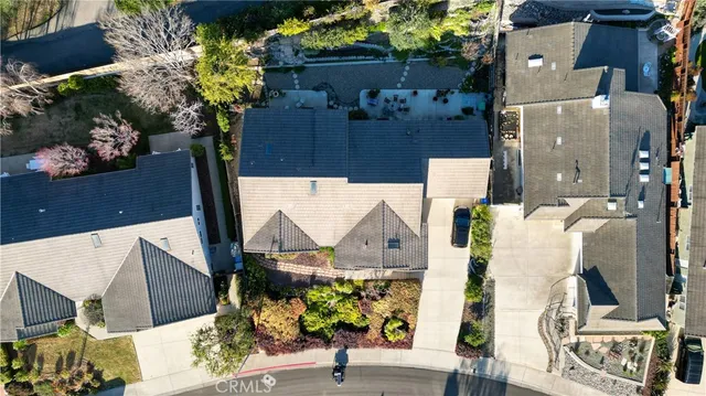 an aerial view of a house with a yard and potted plants