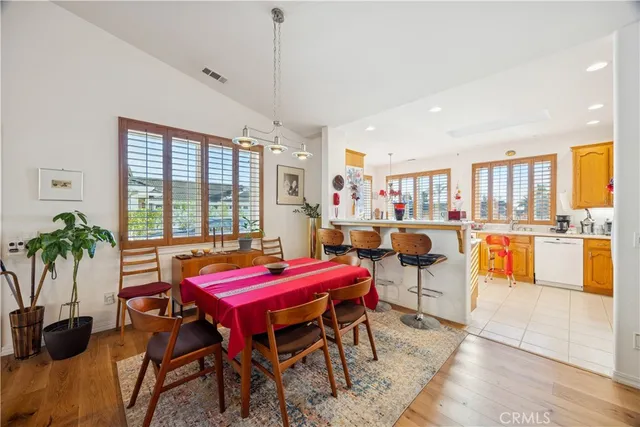 a dining room with furniture and wooden floor