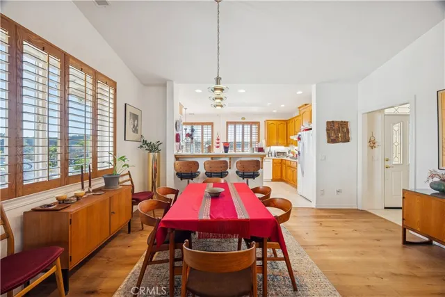 a living room with furniture a large window with table and chairs