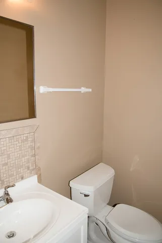 a white toilet sitting next to a bathroom sink