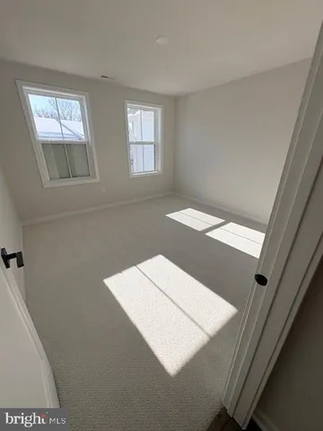 a view of an empty room with windows