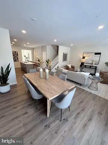 a living room with furniture wooden floor and a potted plant