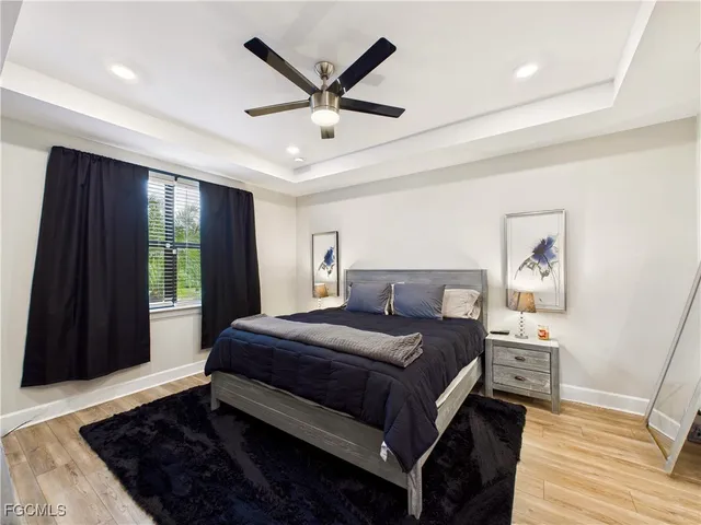 a bedroom with a large bed and a window