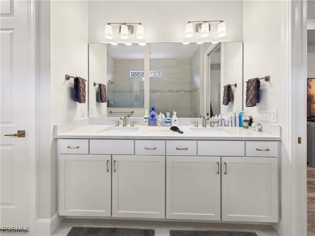 a bathroom with a sink vanity and a mirror