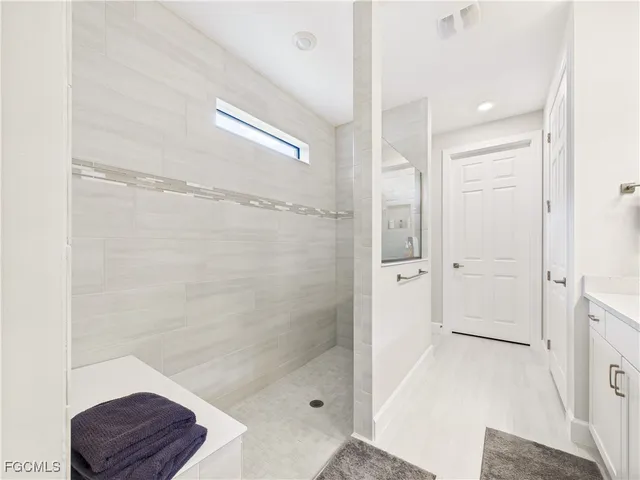 a bathroom with a shower a sink and a toilet