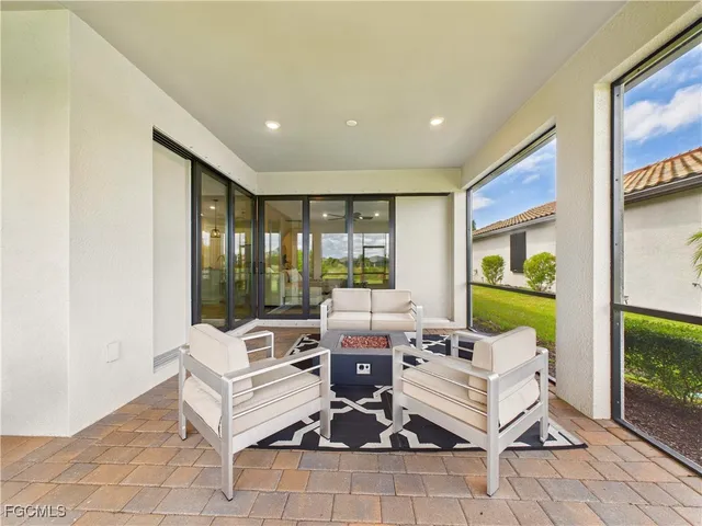 a living room with fireplace furniture and a floor to ceiling window