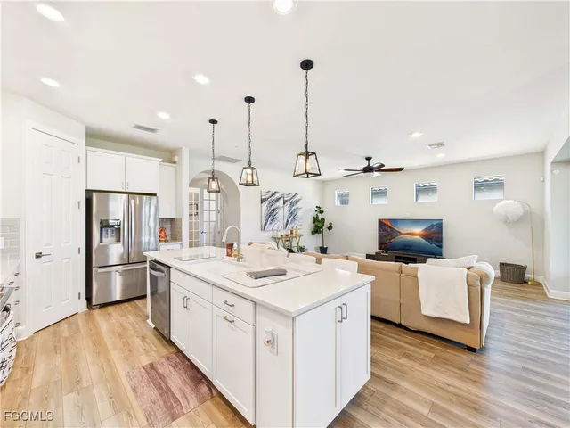 a view of kitchen with stainless steel appliances kitchen island a sink stove and refrigerator