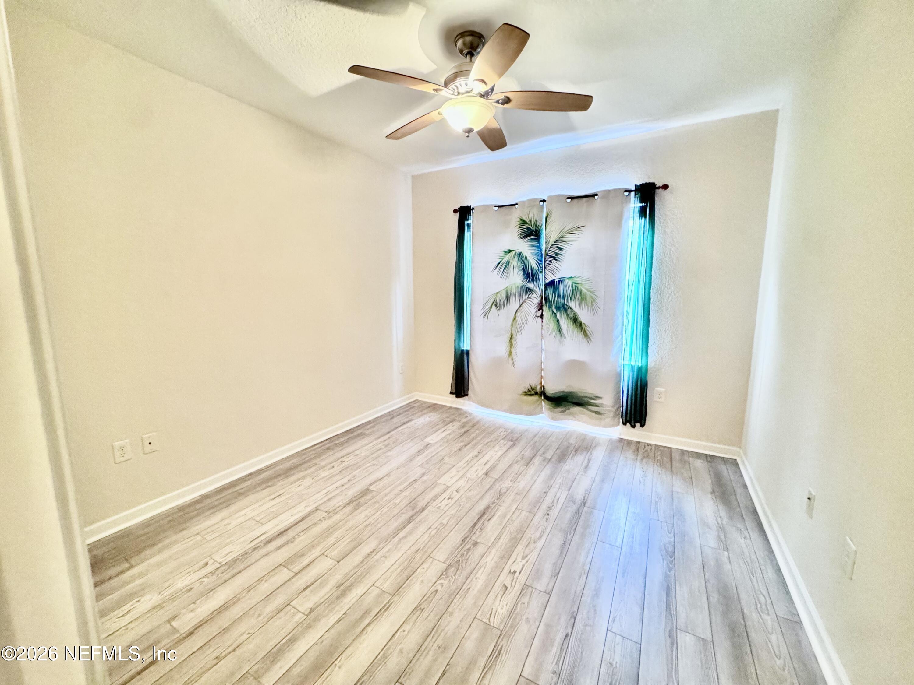 110 Magnolia Crossing Point, Unit 1903 St. Augustine, FL 32086 - Photo 14 of 31 wooden floor in a empty room with a window