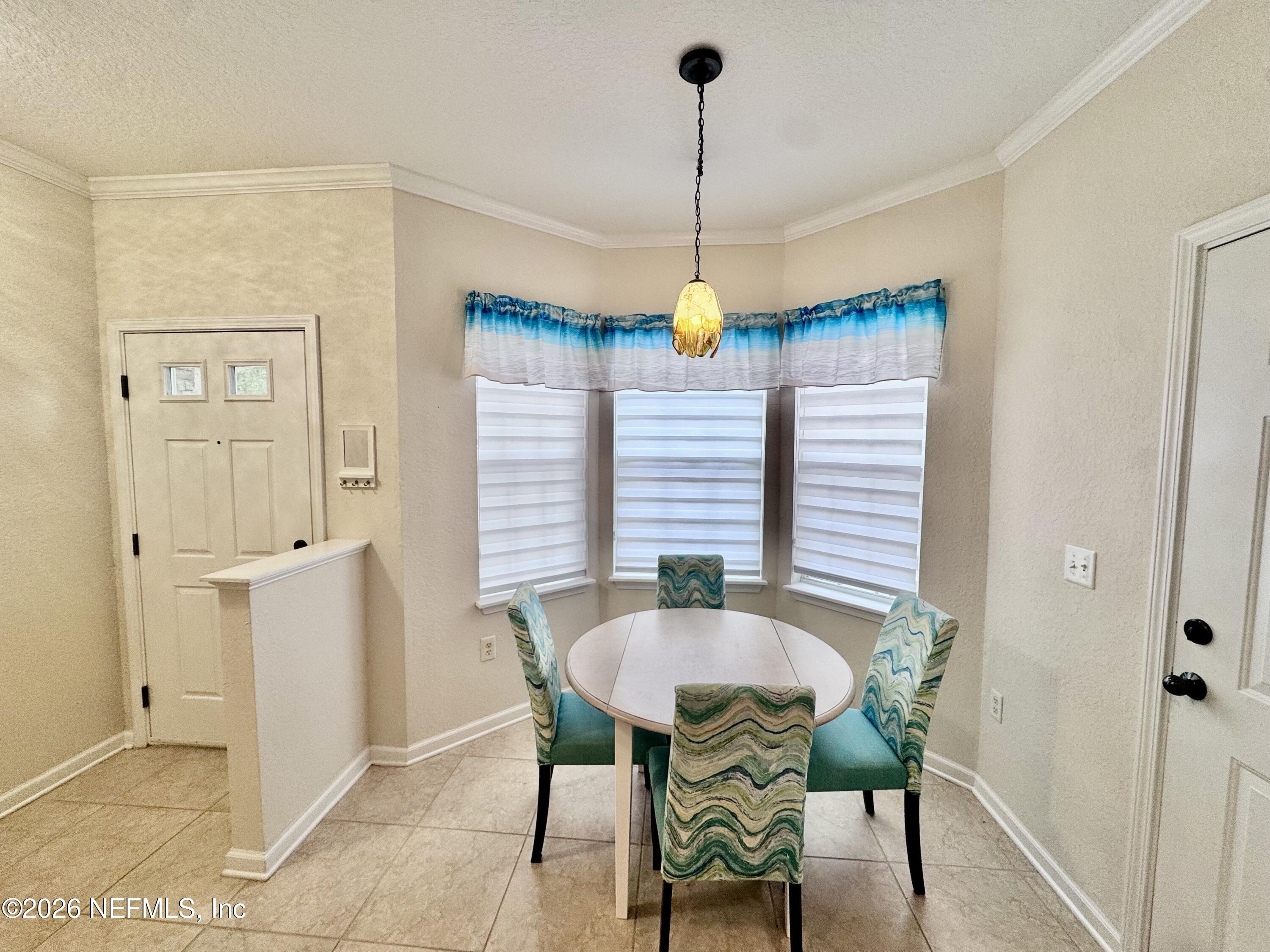110 Magnolia Crossing Point, Unit 1903 St. Augustine, FL 32086 - Photo 17 of 26 a view of a dining room with furniture and window
