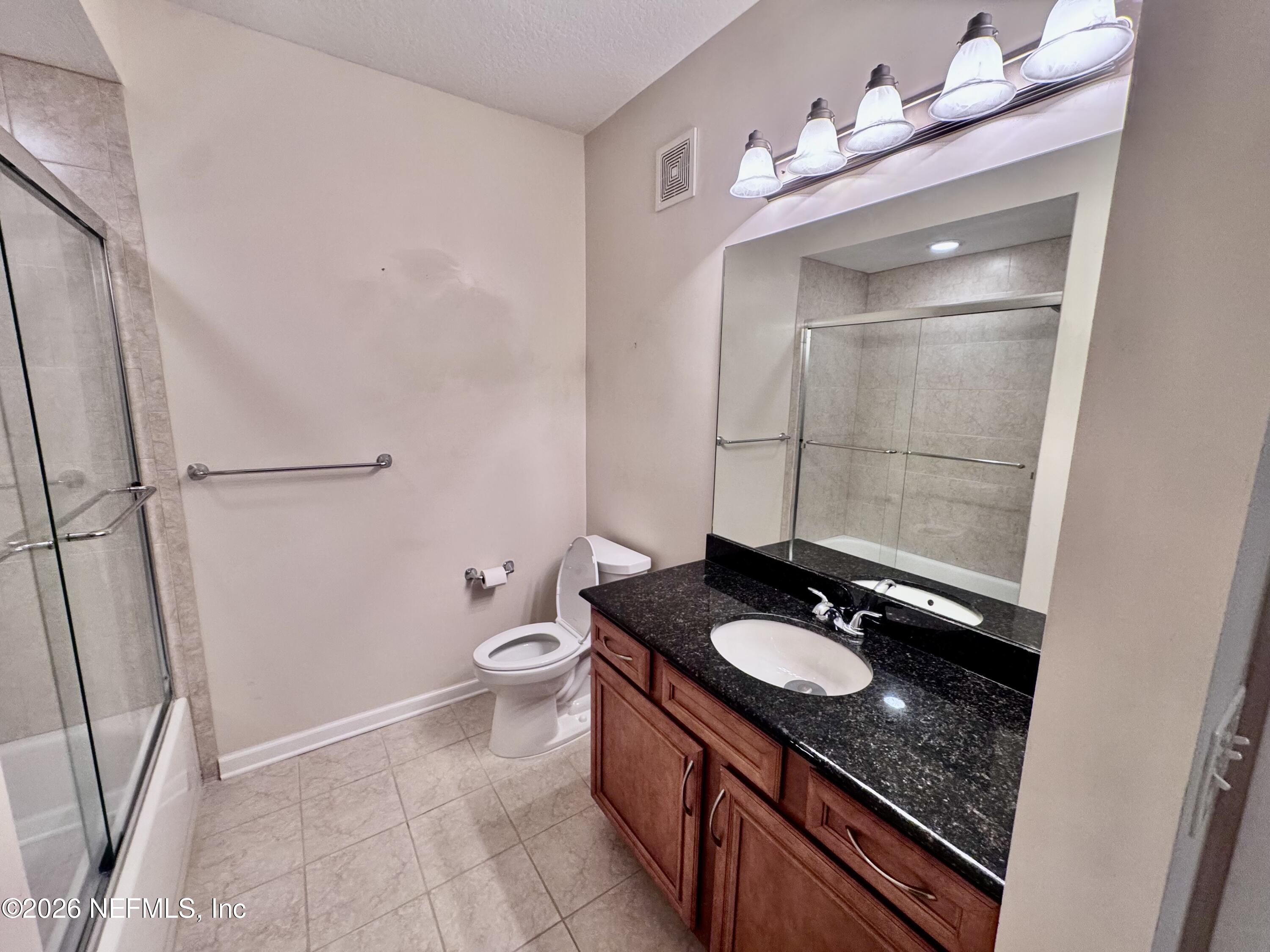 110 Magnolia Crossing Point, Unit 1903 St. Augustine, FL 32086 - Photo 17 of 31 a bathroom with a sink a toilet and shower