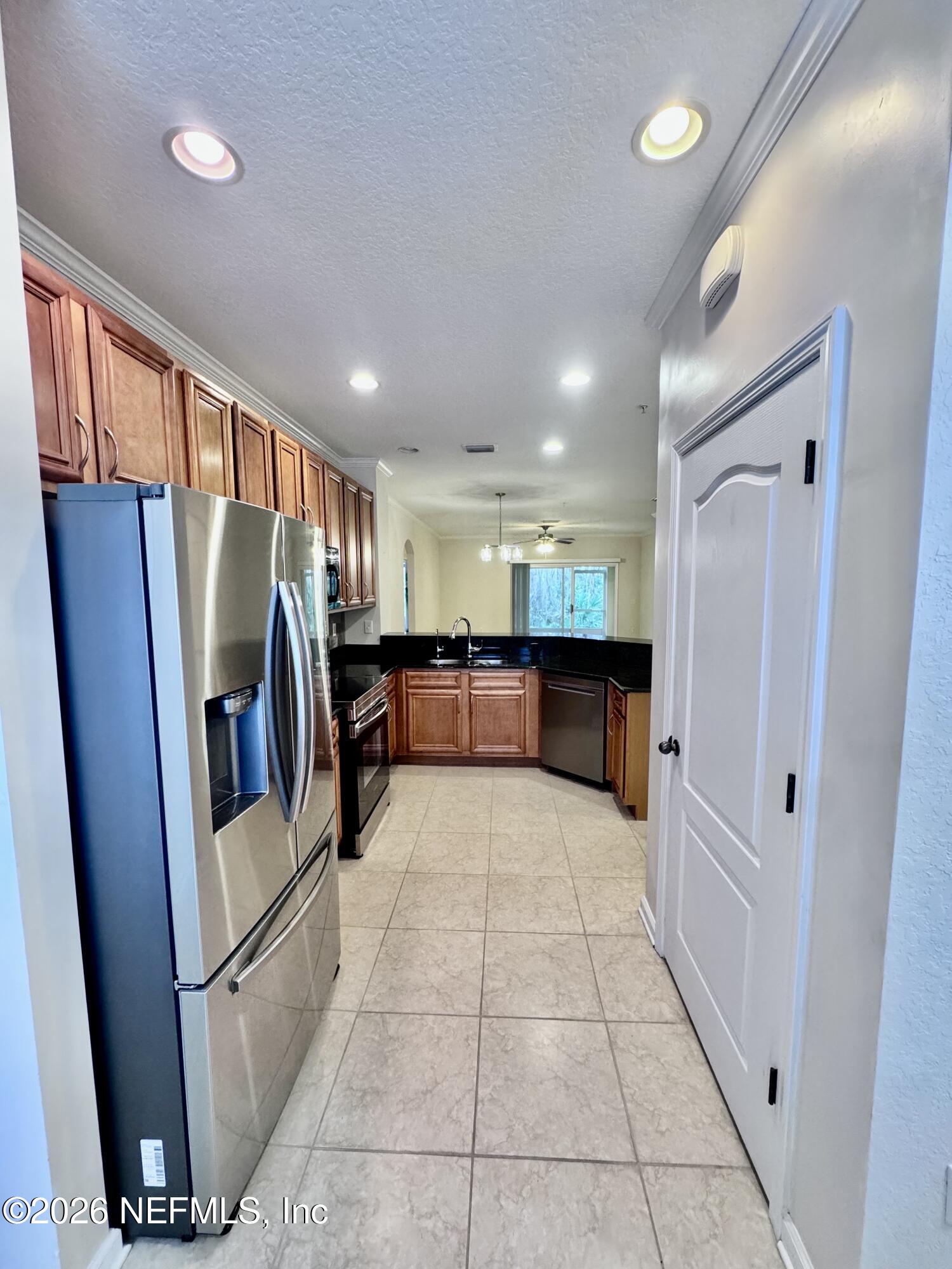 110 Magnolia Crossing Point, Unit 1903 St. Augustine, FL 32086 - Photo 18 of 26 a view of a refrigerator in kitchen and a window