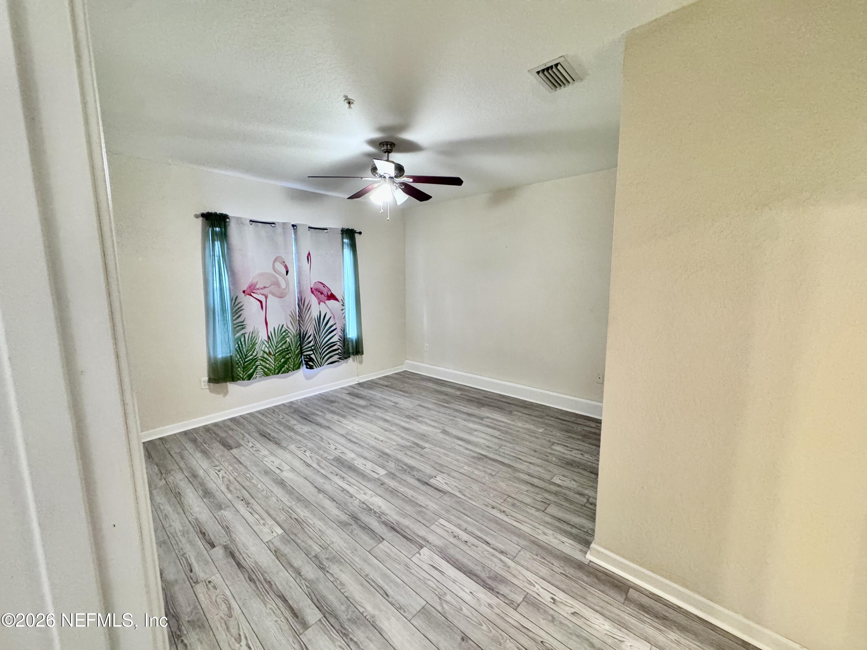 110 Magnolia Crossing Point, Unit 1903 St. Augustine, FL 32086 - Photo 9 of 26 wooden floor in an empty room