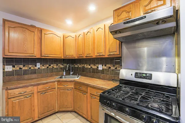a kitchen with stainless steel appliances granite countertop a stove and cabinets