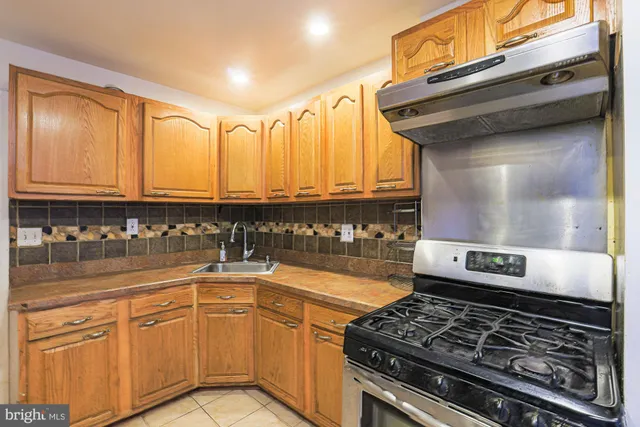 a kitchen with stainless steel appliances granite countertop a stove and cabinets