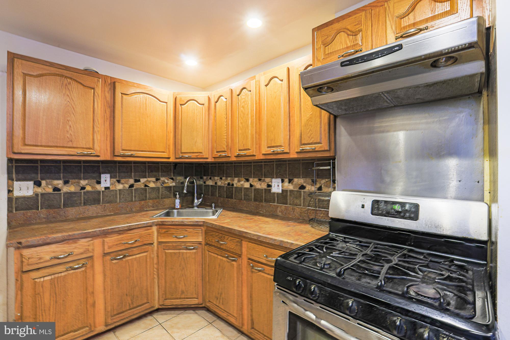 337 Scott Street Baltimore, MD 21230 - Photo 15 of 31 a kitchen with stainless steel appliances granite countertop a stove and cabinets