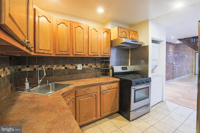 a kitchen with stainless steel appliances granite countertop a sink and cabinets
