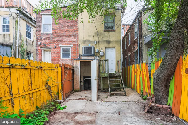 a view of a brick house with many windows and yard