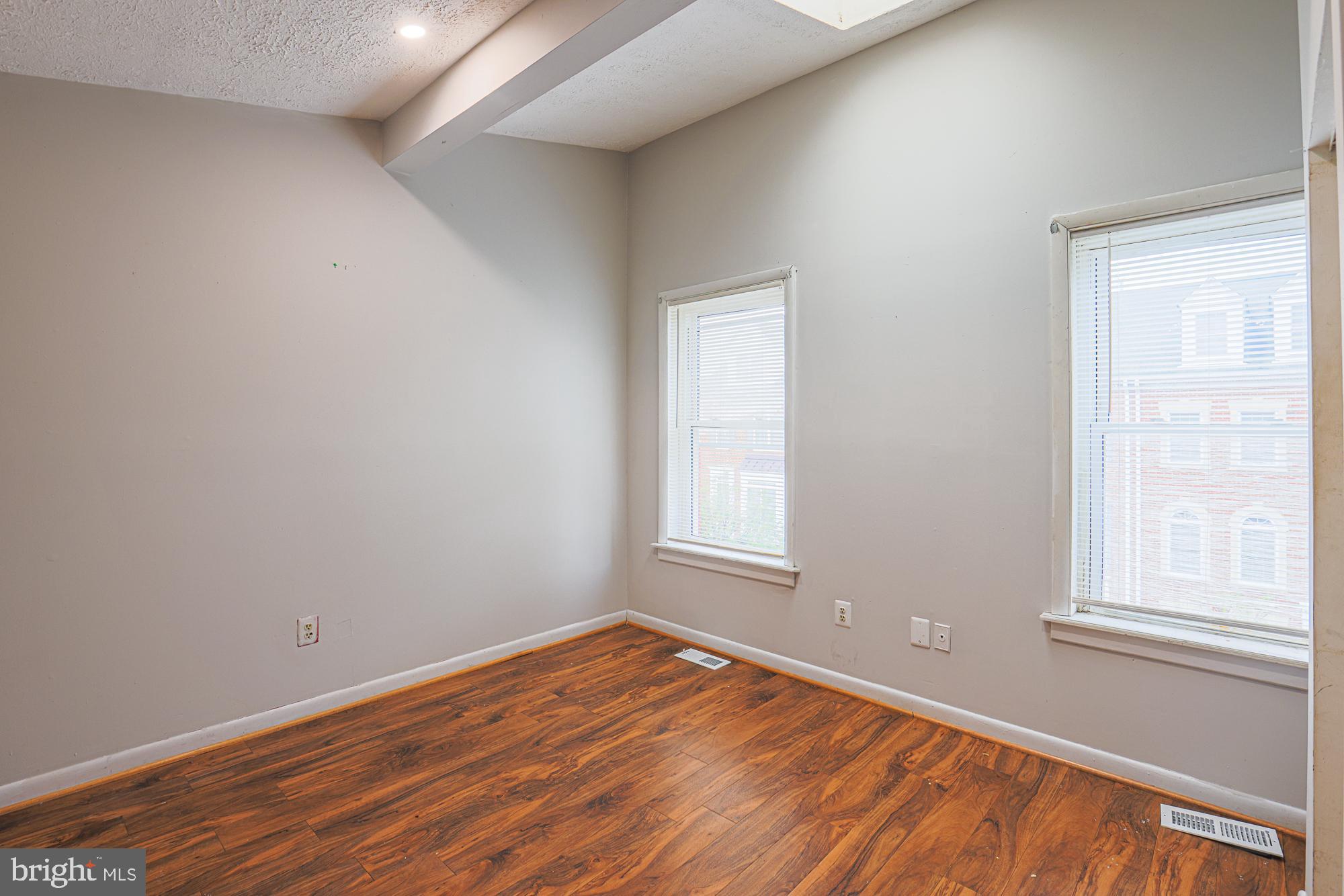 337 Scott Street Baltimore, MD 21230 - Photo 26 of 31 an empty room with wooden floor and windows