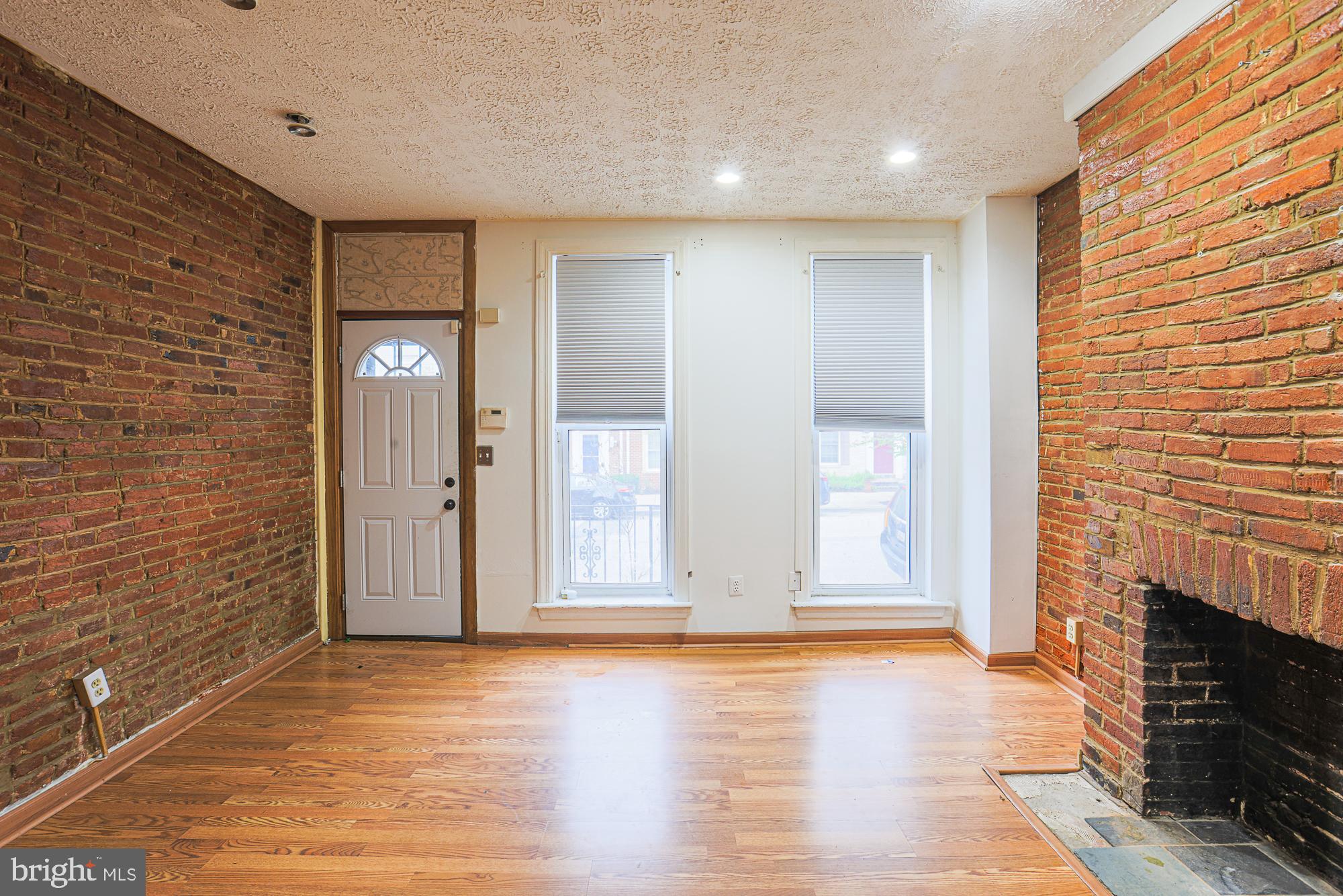 337 Scott Street Baltimore, MD 21230 - Photo 9 of 31 a view of an empty room with wooden floor and a fireplace