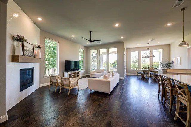 a living room with furniture fireplace and wooden floor