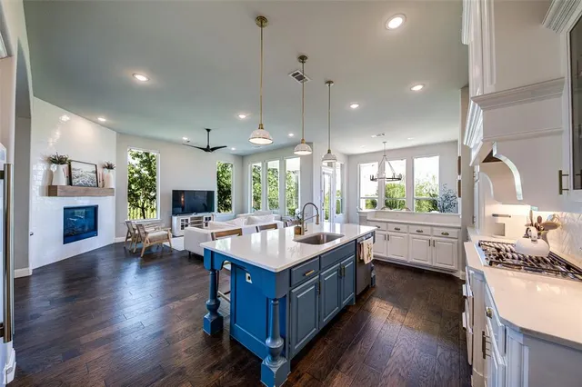 a large kitchen with a stove a table and chairs