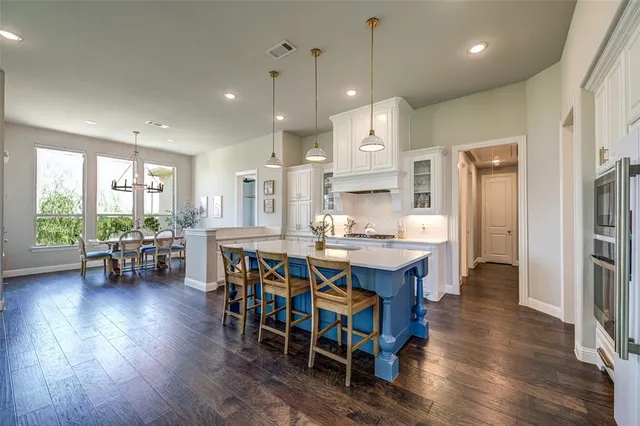 a large kitchen with a table and chairs in it