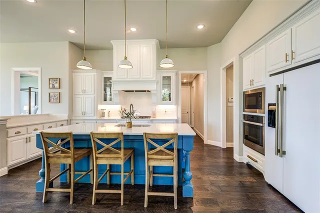 a large kitchen with a table and chairs