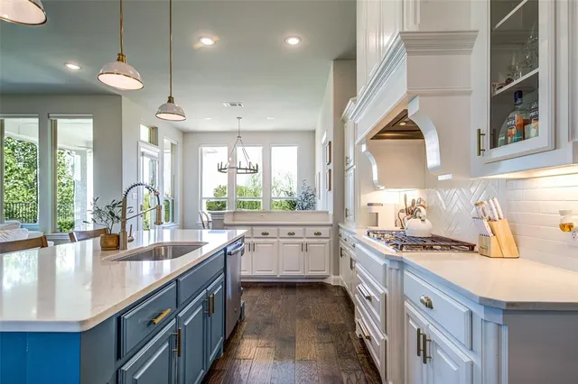 a kitchen with a sink stove and cabinets