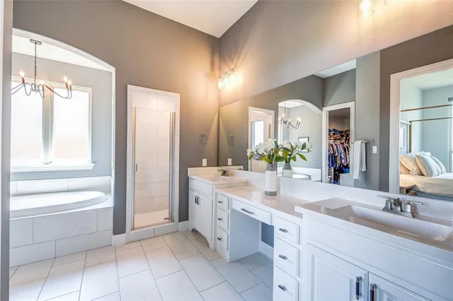 a spacious bathroom with a double vanity sink mirror and a bath tub