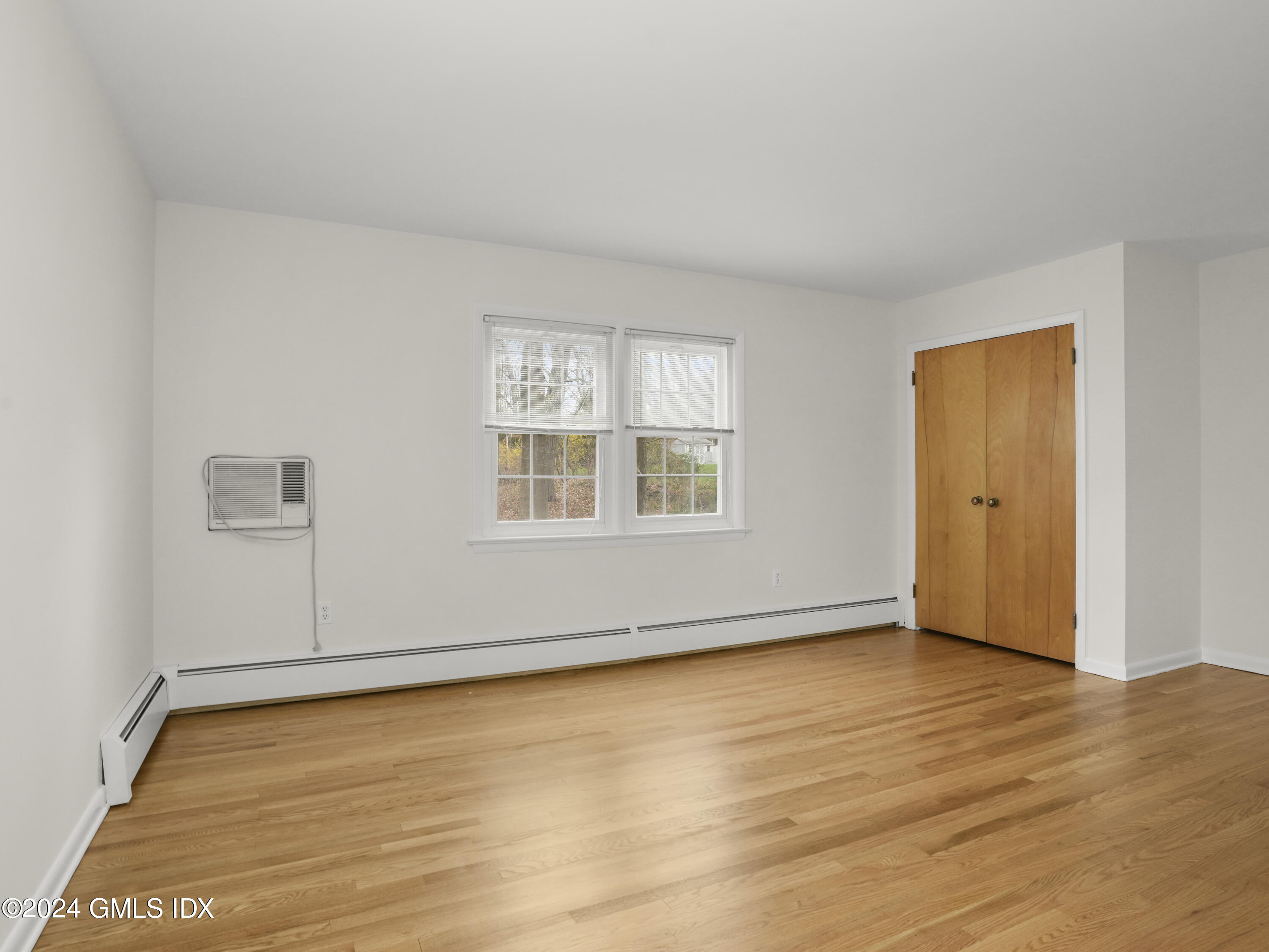 227 Club Road Stamford, CT 06905 - Photo 54 of 56 an empty room with wooden floor and windows
