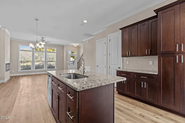 a kitchen with granite countertop a sink and a wooden cabinets