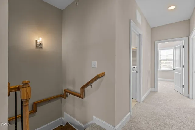 a view of a livingroom with a flesh screen tv and stairs