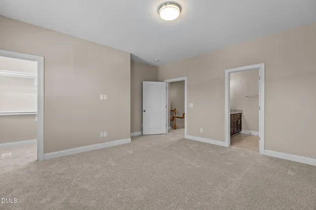 an empty room with closet and a bathroom