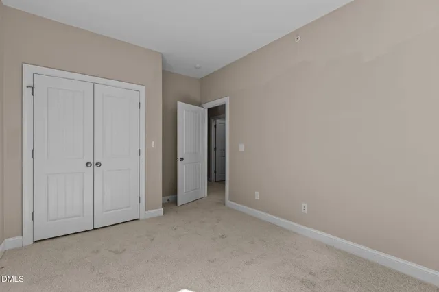 a view of an empty room and closet area