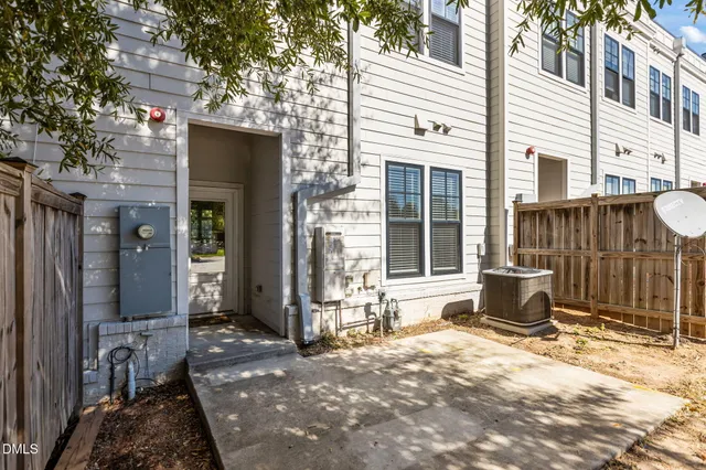 a backyard of a house with yard and furniture