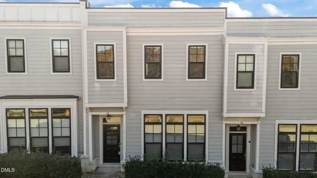 a view of a brick building next to a yard