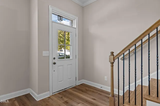 a view of an entryway with wooden floor and stairs