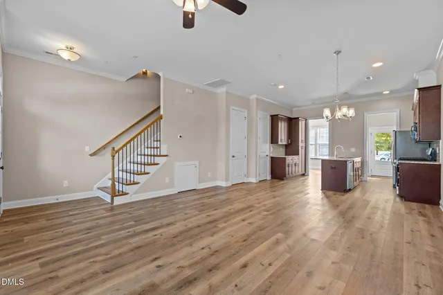 a view of a hallway with wooden floor and seating space
