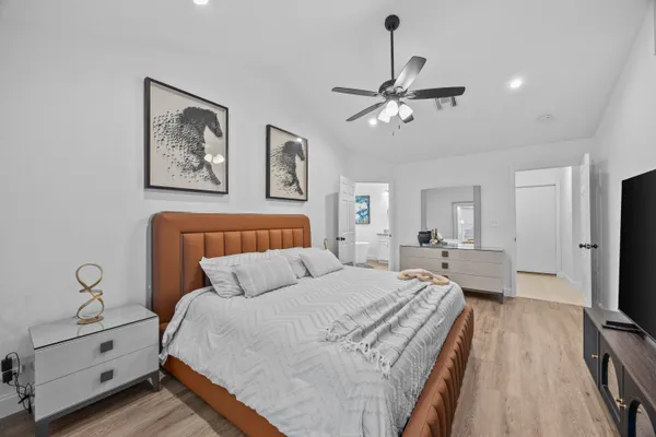 a bedroom with a bed and a chandelier
