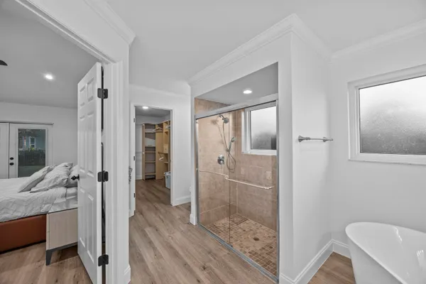 a bathroom with a granite countertop sink mirror and shower