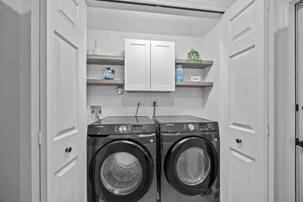 a utility room with sink dryer and washer