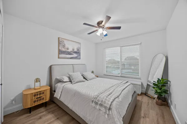 a spacious bedroom with a bed and a window