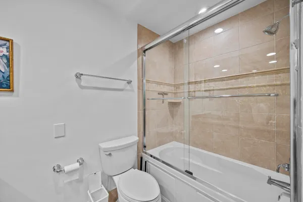 a bathroom with a toilet and a shower