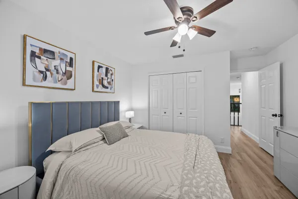 a bedroom with a large bed and a chandelier