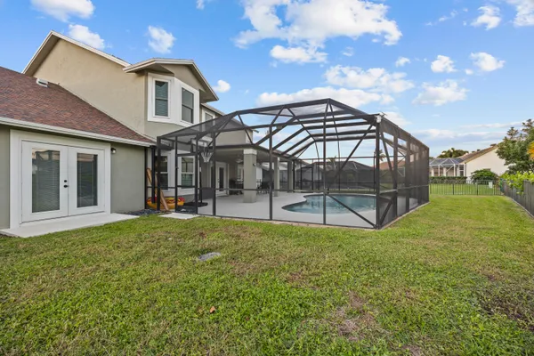 a view of a house with backyard and porch