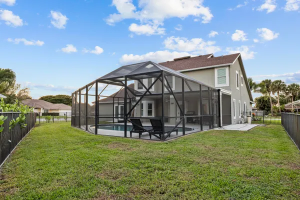 a view of a house with a yard and sitting area