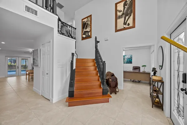 a view of a livingroom with furniture and a hallway
