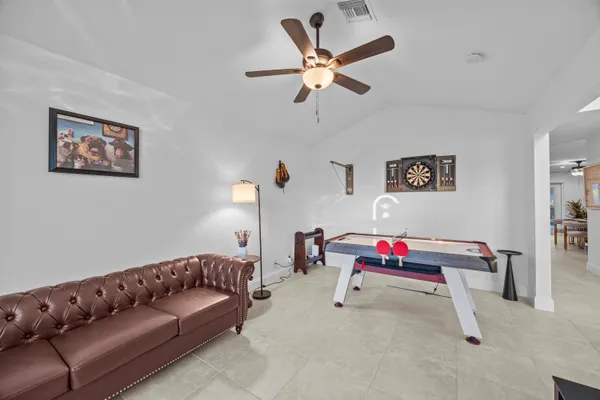 a living room with furniture and kitchen