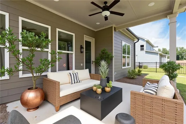 a view of a livingroom with furniture and floor to ceiling window