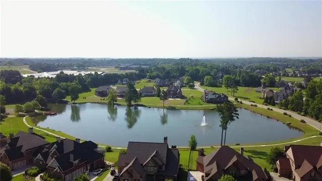 an aerial view of a house with a swimming pool outdoor seating and yard